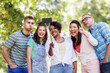 © Syda Productions - people, friendship and international concept - happy smiling young woman and group of happy friends taking picture by selfie stick in park