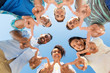 © Syda Productions - people, friendship and international concept - group of happy smiling friends outdoors standing in circle and showing peace hand sign