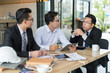 © shutterdemon - three asian businessman meeting and discussing business in office.