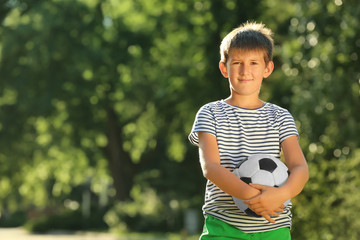 Wall Mural - Cute boy with soccer ball in park