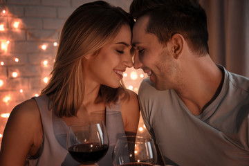 Wall Mural - Young loving couple against blurred lights background