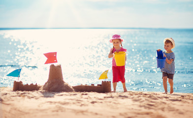 Wall Mural - Boy and girl playing on the beach