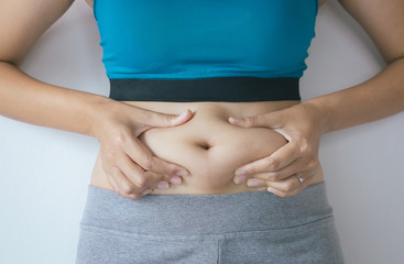 Wall Mural - Woman with excess belly fat and overweight fatty bellys of female