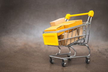 Mini shopping cart contain paper box using as e-commerce, online shopping and business marketing concept