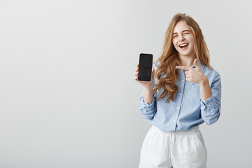 best choice ever. portrait of good-looking caucasian female model with blond hair in blue blouse, wi