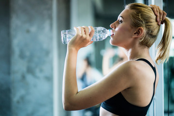  attractive caucasian woman relax with pure water after workout with happiness and joyful in gym healthy ideas concept