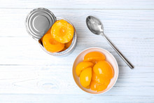 Flat Lay Composition With Canned Peaches On Wooden Background