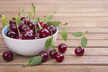 Wall Mural - White plate of ripe cherries