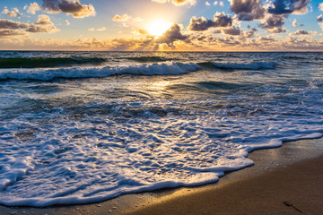 sun rising over the ocean on a florida beach
