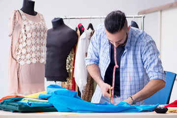 Wall Mural - Male tailor working in the workshop on new designs