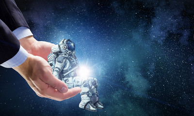 Wall Mural - spaceman on finger. mixed media