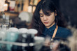 © weedezign - asian woman barista making hot coffee with machine at counter bar in cafe restaurant,Food and drink service concept.