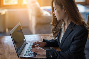 Asian businesswoman working with laptop.