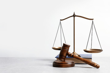 Wooden gavel, scales of justice and book on table. Law concept