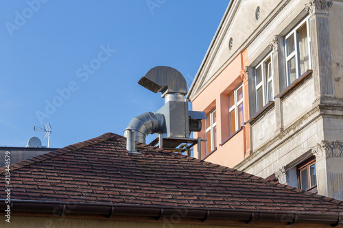 Fotomural Ventilation chimney on the roof with gutter near old apartment house