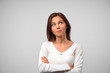 © EverGrump - Cute pensive young Caucasian female tries to gather with thoughts, looks upwards while thinks, doubts in mind, dressed in casual white t shirt, isolated over studio background