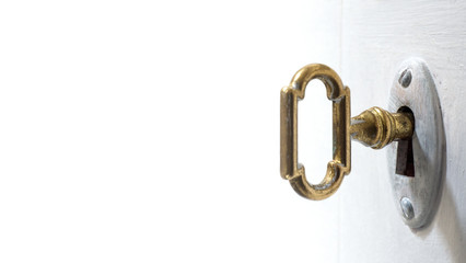 Fototapete - Old key in keyhole, macro shot, white background. Retro style. Concept and Idea for History, business, security background. Write Your Text Here.