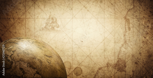 Ancient old globe on the vintage map background. Selective focus. Retro style...