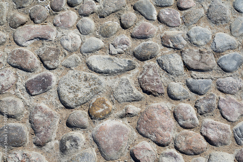 Fotografía Grey cobblestone texture of a ground with many stones