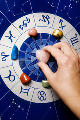 astrologer, fortune teller with astrology background withd zodiac signs and magic gem stones