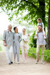 © pressmaster - Cheerful family in casualwear walking down road in natural environment during chill
