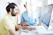 © pressmaster - Young creative man and his colleagues sitting in front of computer monitor and working over new design project at meeting