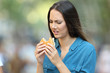 Woman eating a burger with bad taste