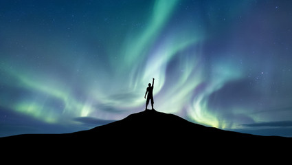 Wall Mural - silhouette of a championat the northen light background. sport and active life concept and idea of s