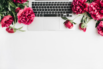 Wall Mural - Laptop and pink peonies flowers on white background. Flat lay, top view summer background.