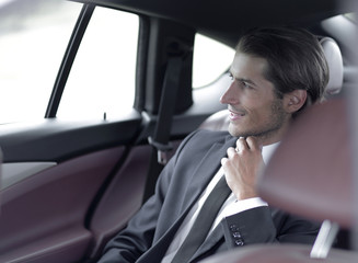 Wall Mural - serious businessman sitting in car