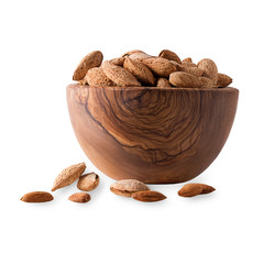 Poster - Wooden bowl full of almonds with shell on white