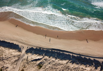 Top view aerial photo from flying drone of beauty nature landscape turquoise water with Wanda beach in winter day in Cronulla. Amazing seascape with waves and walking people. Travel vacation concept.