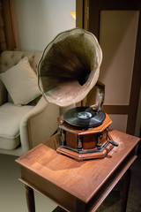 Antique classic retro gramophone on wooden table. Music box. Vintage interior concept.