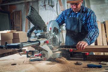 carpenter work with circular saw for cutting boards, the man sawed bars, construction and home renov