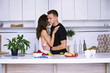 © mikitiger - cute young woman and man in white kitchen near table in house