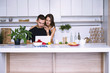© mikitiger - cute young woman and man in white kitchen near table in house