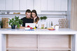 © mikitiger - cute young woman and man in white kitchen near table in house