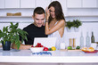 © mikitiger - cute young woman and man in white kitchen near table in house