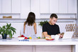 © mikitiger - cute young woman and man in white kitchen near table in house