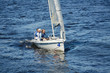 © pressmaster - Group of men sitting on sailboat deck and sailing with professional while floating on river