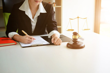 Lawyer woman working on workplace with window light at morning time.