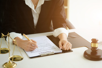 Lawyer woman working on workplace with window light at morning time.