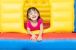 Leinwandbild Motiv Asian Little Chinese Girl playing at inflatable castle