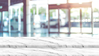 Poster - Empty step white marble table top with blur corridor hallway at office building with bokeh light at background,Mock up template for display of your design,Banner for advertise of product.
