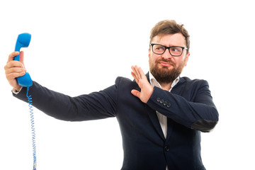 Wall Mural - Business man holding blue receiver and showing stop screaming gesture.