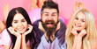 © be free - Cheerful morning concept. Man and women, friends on smiling faces lay, pink background. Lovers in love happy together. Bearded man and women in domestic clothes, pajamas. Threesome relaxing in morning