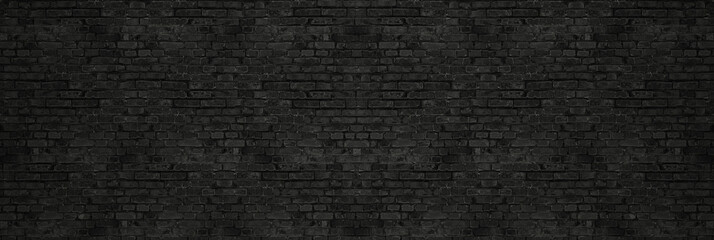 vintage black wash brick wall texture for design. panoramic background for your text or image.