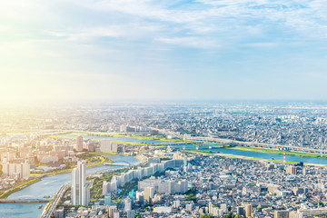 Wall Mural - Asia Business concept for real estate and corporate construction - panoramic modern city urban skyline bird eye aerial view under sun & blue sky in Tokyo, Japan