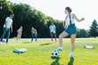 © LIGHTFIELD STUDIOS - happy teenage multiethnic friends playing with soccer ball in park