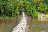 Fototapeta Mosty linowy / wiszący - wooden bridge over the mountain river, Georgia